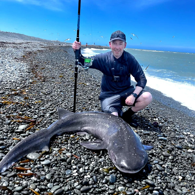Daniel with a shark on a Canterbury pebble beach
